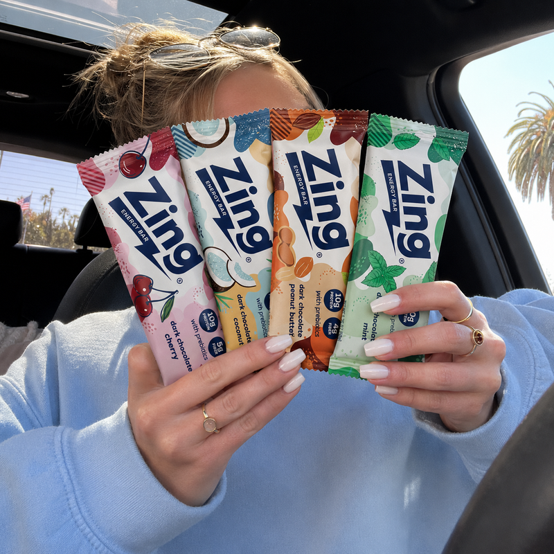 girl sitting in car holding zing bars